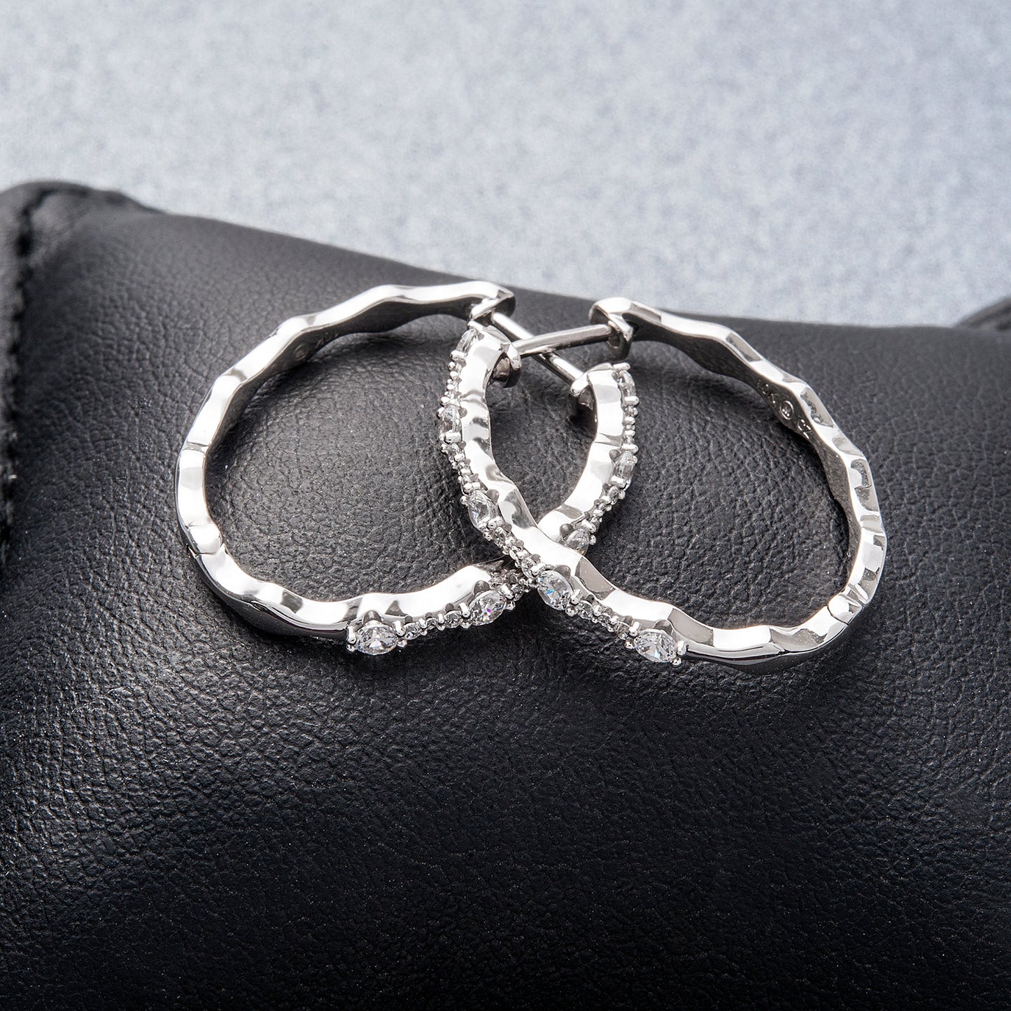 Eyrna Diamond Hoop Earrings Placed on Black Cusion