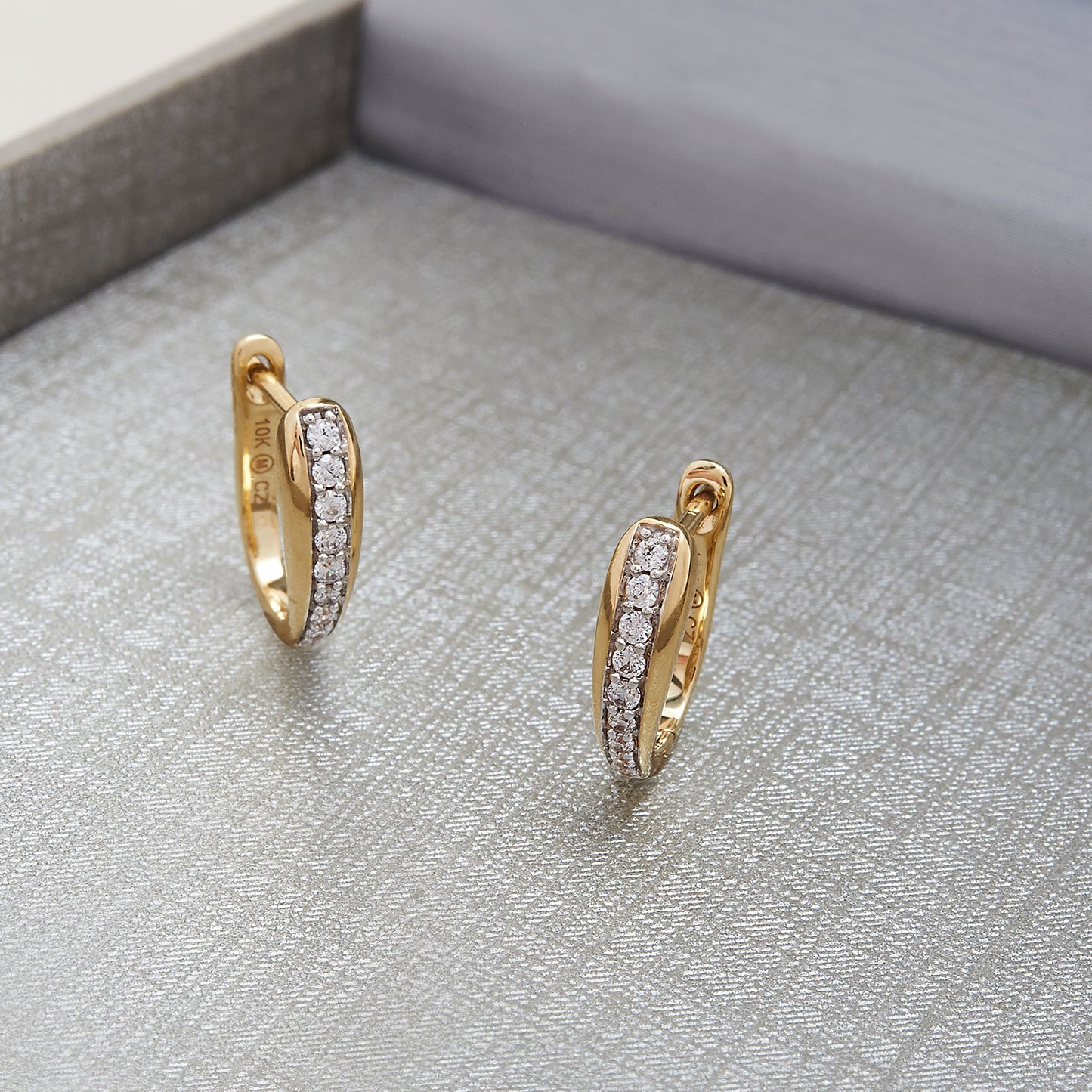 Harper Huggie Hoop Earrings Placed In the Box
