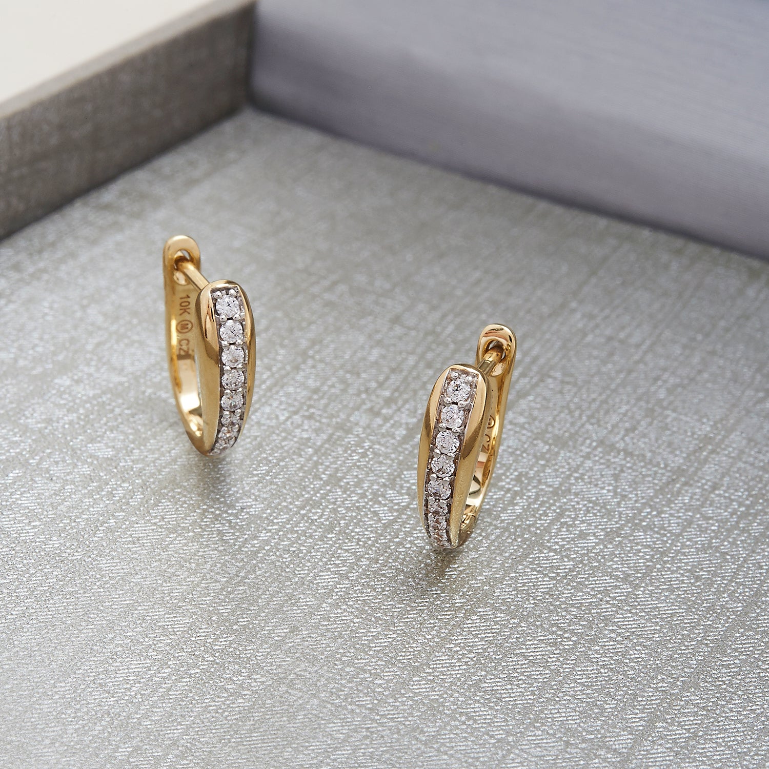 Harper Huggie Hoop Earrings Placed In the Box