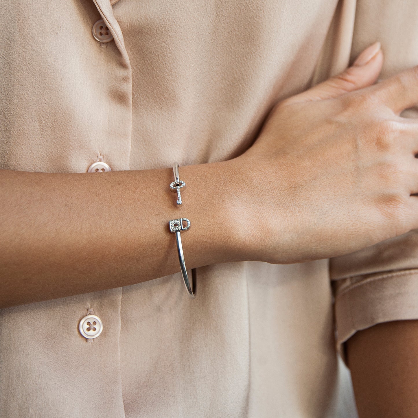Beth Key & Lock Bangle in Lady's Hand