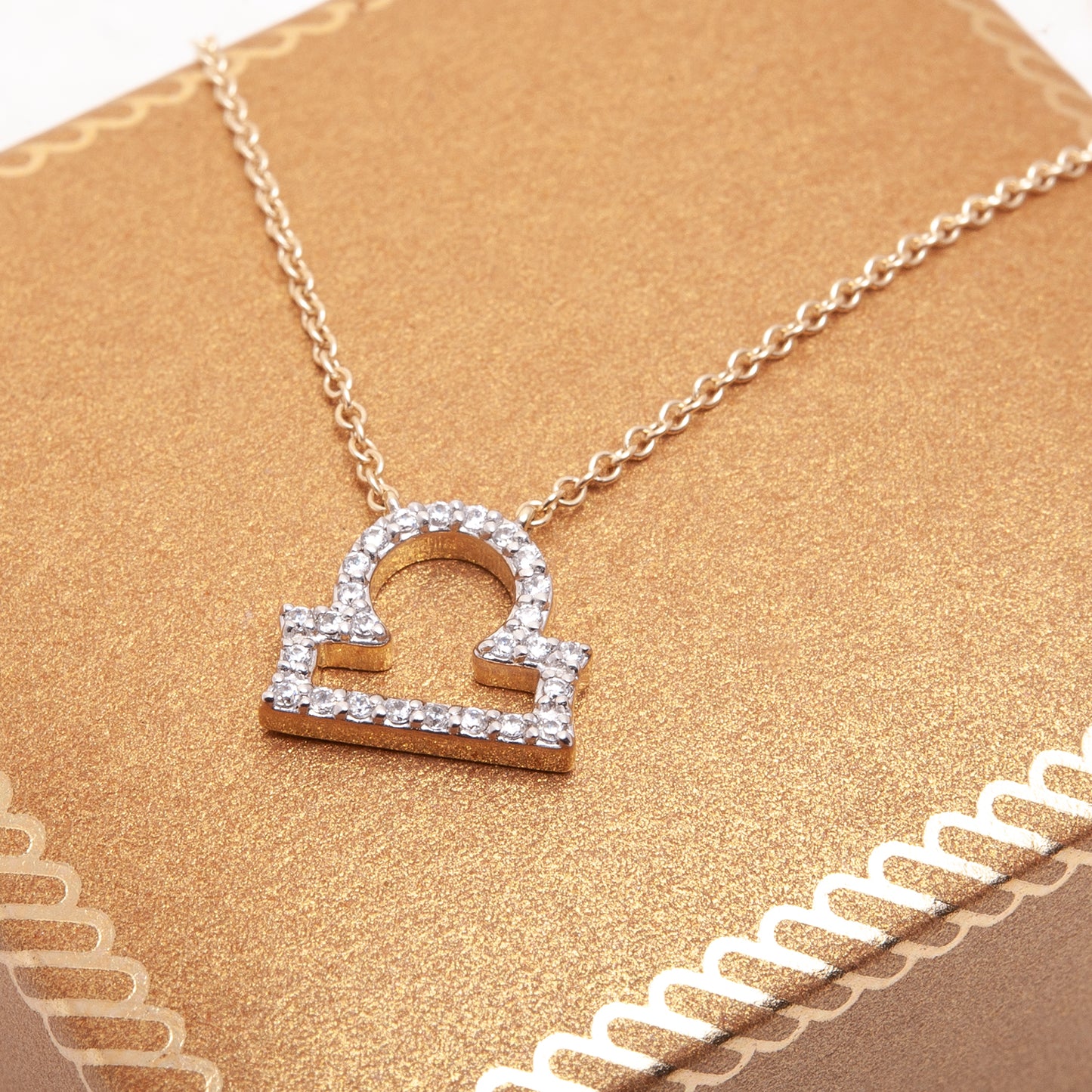 Libra Zodiac Diamond Necklace In Gold With Gold Chain Placed On Box