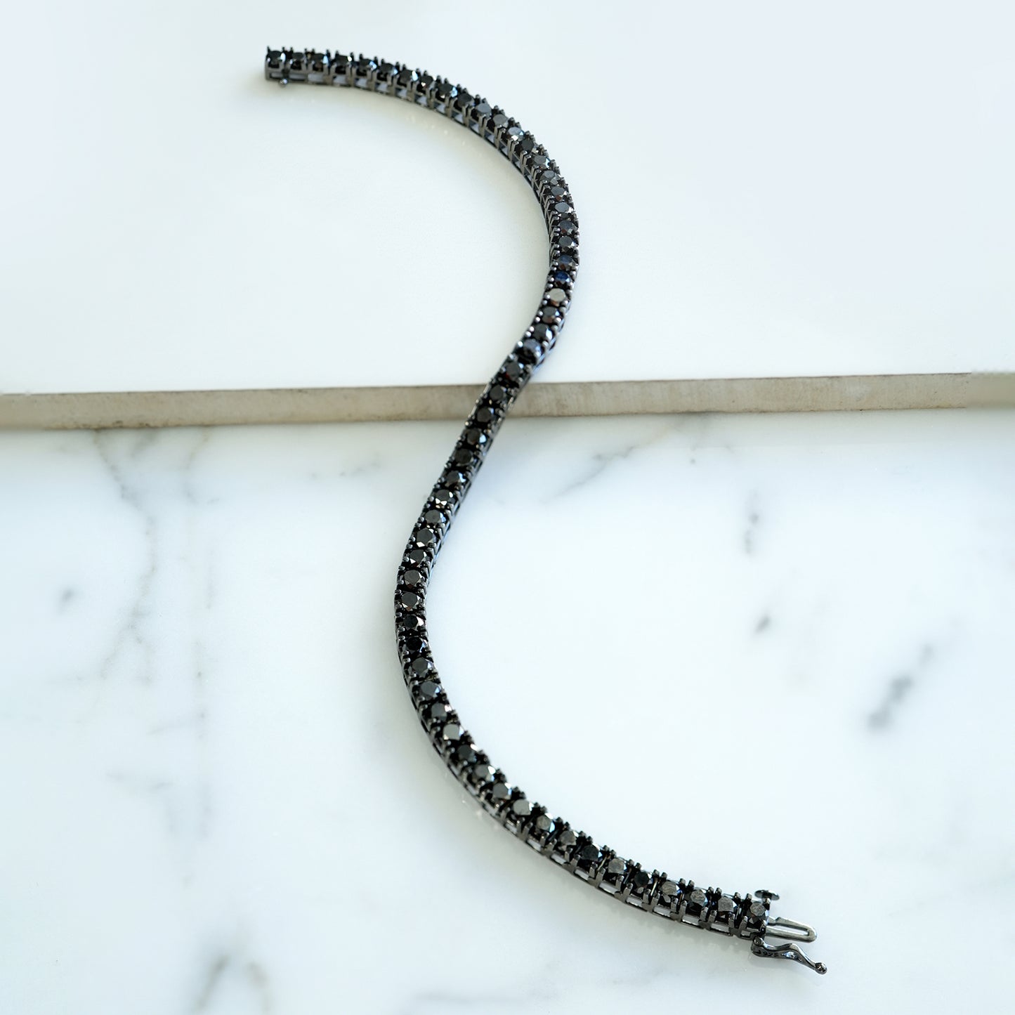 Black Diamond Tennis Bracelet on Table