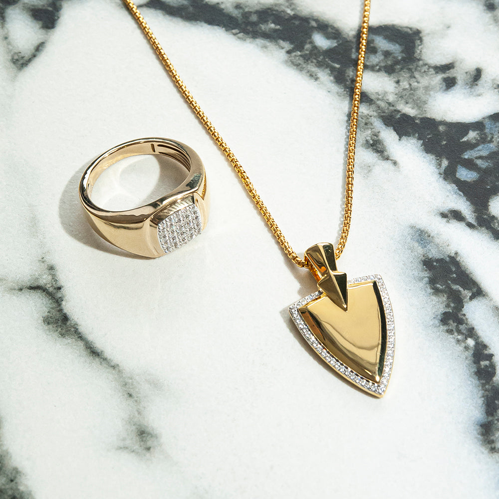Diamond Shield Pendant Placed On the Table