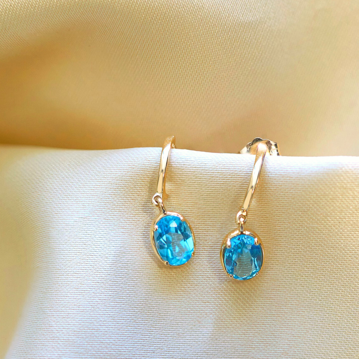 Blue Topaz Oval Dangle Earrings stick on Cloth