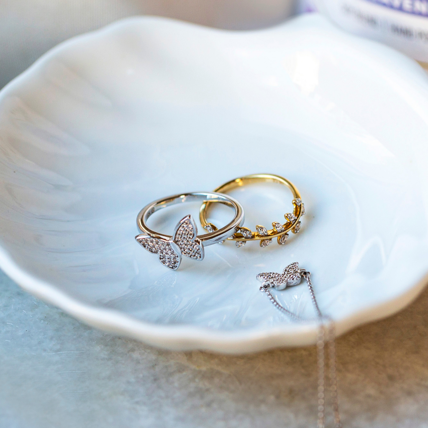 Lilly Diamond Butterfly Ring In Silver & Gold Placed In Bowl
