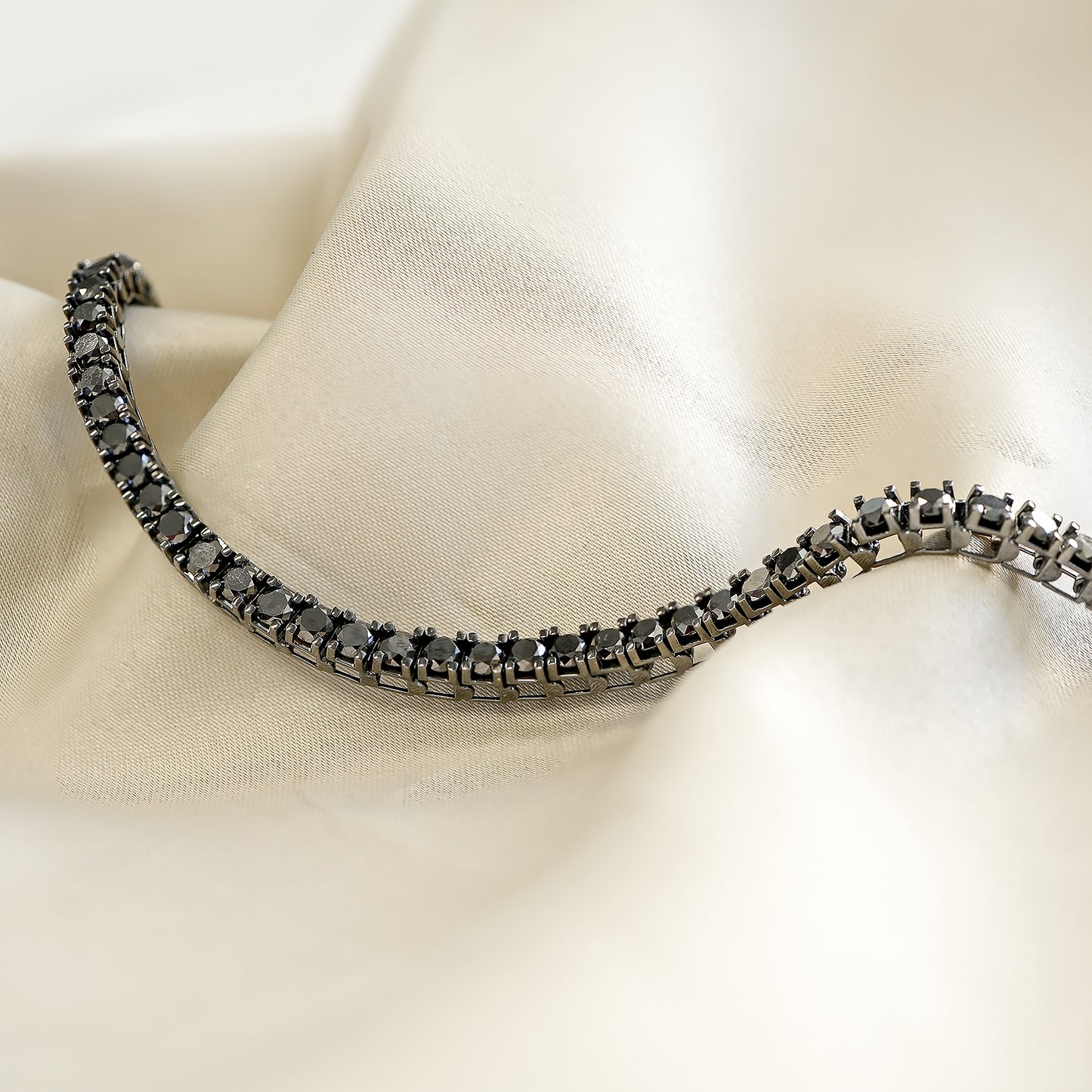 Black Diamond Tennis Bracelet Placed on Cloth